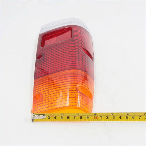 Rear tail light lens for Nissan Datsun 720 1980-1989 with red and amber dual-section textured lens back view