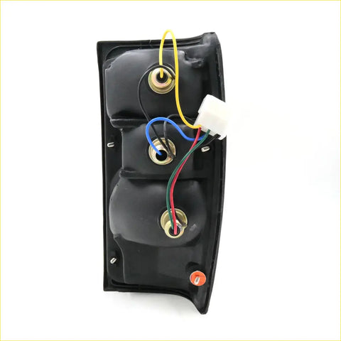 Black plastic rear tail light lhs for toyota hilux 1984-1988 with gold mounting hardware and multi color wiring back side