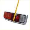 Rear tail light set for toyota hilux 2nd gen 1972-1978 with gray plastic housing and red clear lenses back view