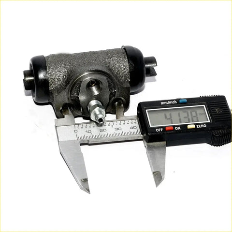 Black cast iron rear wheel brake cylinder with threaded studs measured by digital caliper for mitsubishi pajero montero