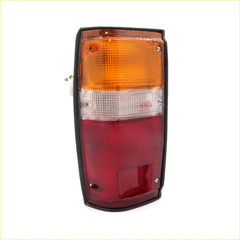 Black-framed rhs rear tail light for toyota hilux 1984-1988 with amber clear and red lens sections backside view
