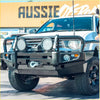 Black metal rockarmor brushbar with two circular led lights and winch mount on white mitsubishi triton mn/ml pickup