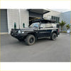 Black nissan patrol 4wd with rugged offroad tires and rockarmor brushbar for gt bullbar roof rack setup