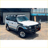White nissan patrol 4wd with black rockarmor brushbar, roof rack, and side steps perfect for offroad ute adventures