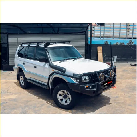 White nissan patrol 4wd with black rockarmor brushbar, roof rack, and side steps perfect for offroad ute adventures