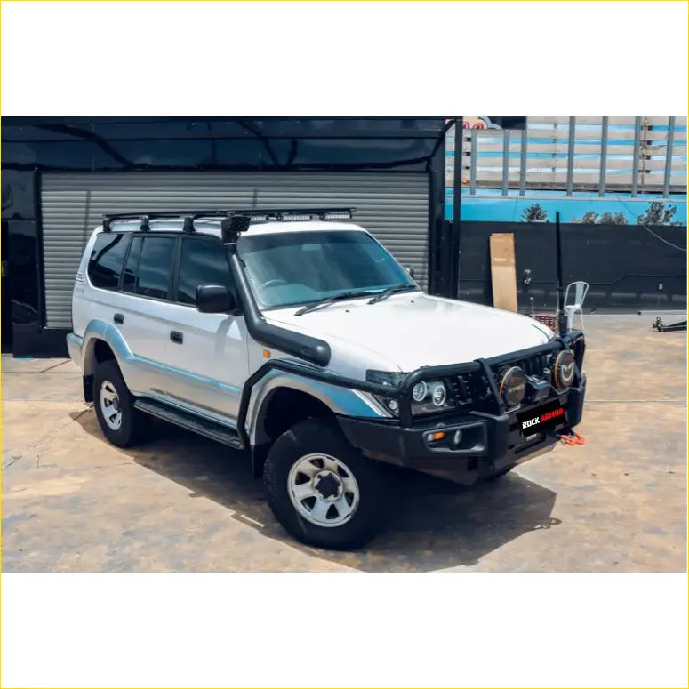 White nissan patrol 4wd with black rockarmor brushbar, roof rack, and side steps perfect for offroad ute adventures