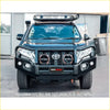 Black rockarmor elite steel bullbar with integrated headlights and toyota emblem fitted to 4wd prado fj150 ute