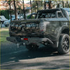 Black rockarmor elite steel rear step bumper with tow hooks and side pipes on mitsubishi triton ute for 4wd offroad use