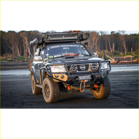Black nissan patrol 4wd with rockarmor gt hoop bullbar combo rugged offroad tires and roof rack for ute adventures