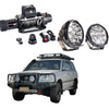 Silver toyota land cruiser 4wd with black steel rockarmor gt hoop bullbar and roof rack for offroad use