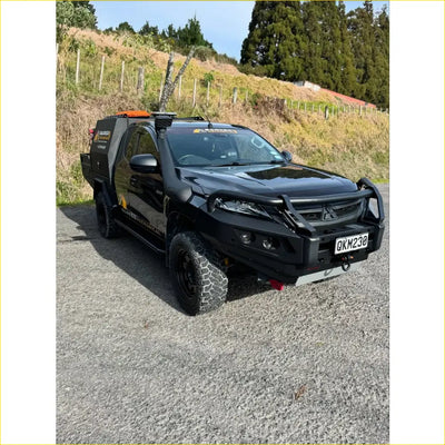 Black mitsubishi triton ute with rockarmor gt hoop steel bullbar and rugged offroad tires for 4wd use