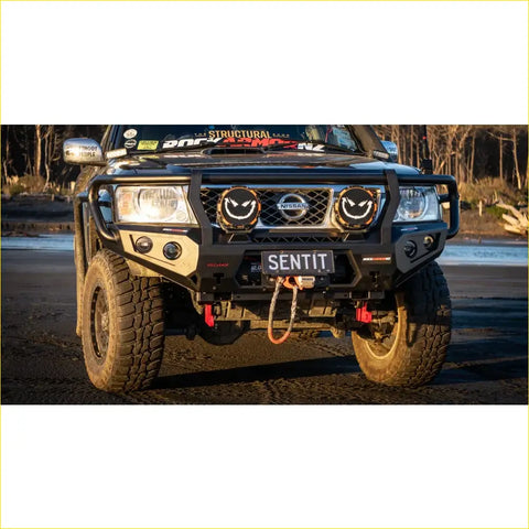 Black steel rockarmor gt hoop bullbar with circular smiling headlights and nissan emblem for offroad 4wd ute