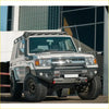 Silver toyota land cruiser 70 with rockarmor gt hoopless steel bullbar combo package and black offroad 4wd tires