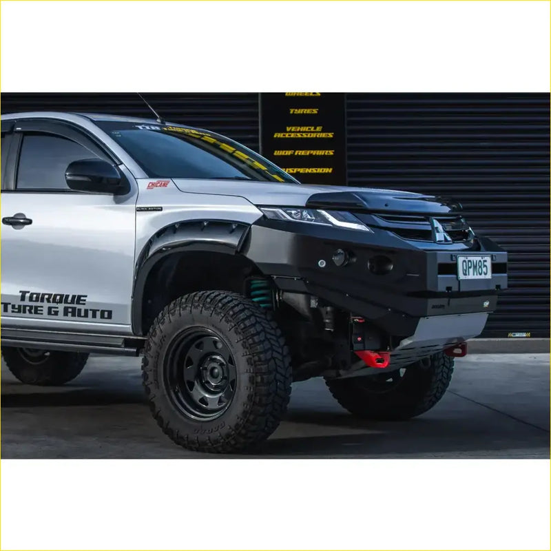 Black steel Rockarmor gt hoopless bullbar with winch mount and red recovery points on silver Mitsubishi Triton ute 4wd