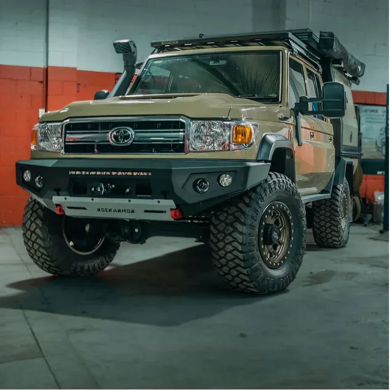Tan toyota land cruiser 70 with black rockarmor gt hoopless steel bullbar and offroad tires for 4wd use