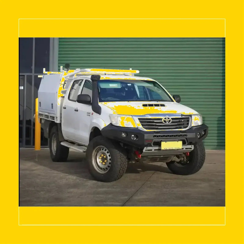 White toyota hilux with yellow accents featuring rockarmor gt hoopless steel bullbar for rugged off-road use