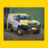 White toyota hilux with yellow accents featuring rockarmor gt hoopless steel bullbar for off-road protection