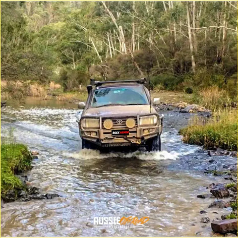 Brown toyota land cruiser with rockarmor premium bullbar front bumper and roof rack for offroad 4wd use