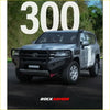 Silver toyota land cruiser 300 with black rockarmor front bumper and grille from rockarmor rock pack gt hoop bullbar and rock sliders