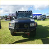 Black armored Toyota Landcruiser 79 with gt hoop bullbar and roof rack for off-road protection and utility