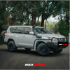 Silver toyota land cruiser prado 4wd with black rockarmor rock sliders side steps and rear spare tire offroad setup