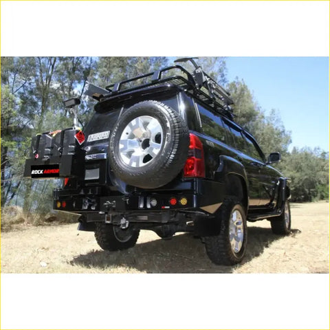 Back view of black steel rockarmor dual wheel carrier rear bumper with spare tire mount and roof rack for 4wd offroad ute