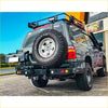 Black matte rockarmor steel dual wheel carrier mounted on rear of 4wd toyota landcruiser fj105 offroad ute