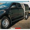 Black Isuzu Dmax 08/20+ pickup truck with 52mm diameter steel rock sliders Rockarmor side steps visible from the back side