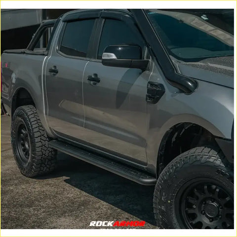 Gray metallic ford ranger ute with black offroad tires featuring rockarmor steel rockslider side steps for 4wd use