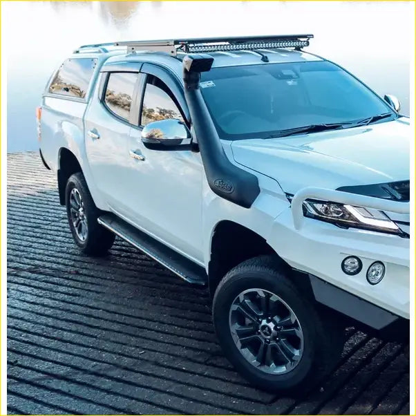 White mitsubishi triton ute with rockarmor steel rockslider side steps black roof rack and snorkel for offroad 4wd use