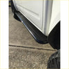 Black textured steel rockarmor rockslider side step with durable finish mounted on white nissan navara d40 ute for offroad 4wd