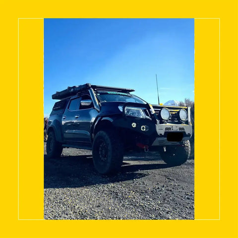 Black nissan navara np300 d23 with rockarmor steel rockslider side steps rugged off-road build and roof rack