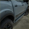 Black diamond plate steel rockarmor side step with mountain graphic on gray nissan navara np300 d23 2015+