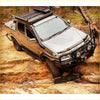 Silver toyota hilux ute with black offroad rockarmor steel rockslider side steps and rugged 4wd tires