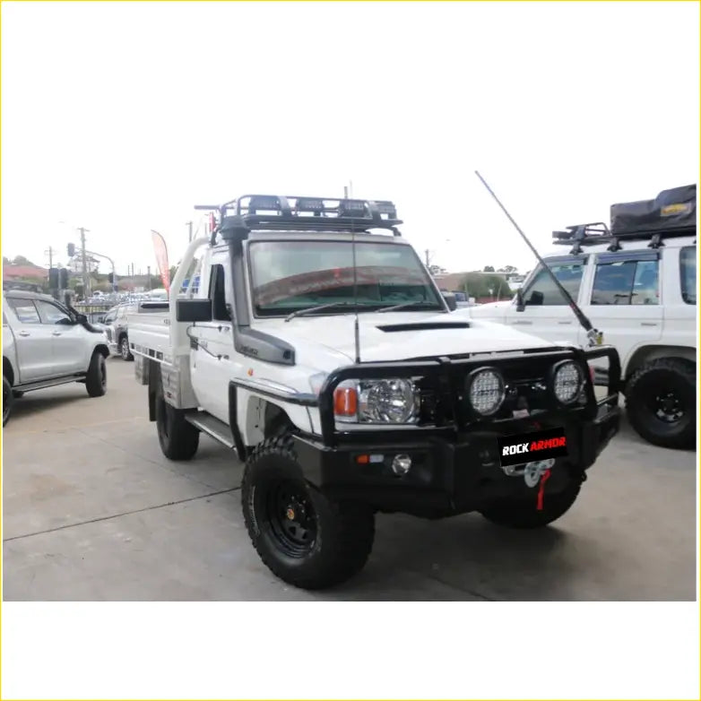 White toyota land cruiser ute with black offroad steel rockarmor rockslider side steps and roof rack for 4wd use