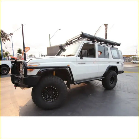 White toyota land cruiser 70 with black steel rockarmor rockslider side steps perfect for offroad 4wd ute use