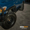 Blue Toyota Landcruiser 78 Series V8 troop carrier with rockarmor steel rockslider side steps and black bull bar wheels