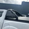 Black perforated metal roll bar with curved tubular bars and mounting brackets for mazda bt-50 2021+ truck bed rail