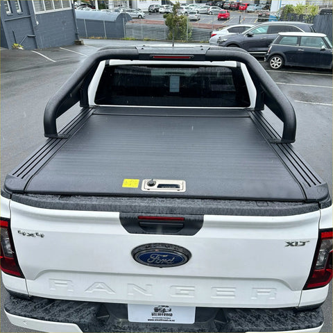 Black durable roll-up tonneau cover with sleek ribbed texture and handle for ford ranger xlt 2022+ back view
