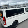 White toyota hiace van with black tinted windows and black wheels featuring heavy duty roof rack 3 piece set rear view