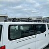 Black heavy duty metal roof rack 4 piece set mounted on back of white nissan nv350 caravan 2012-current