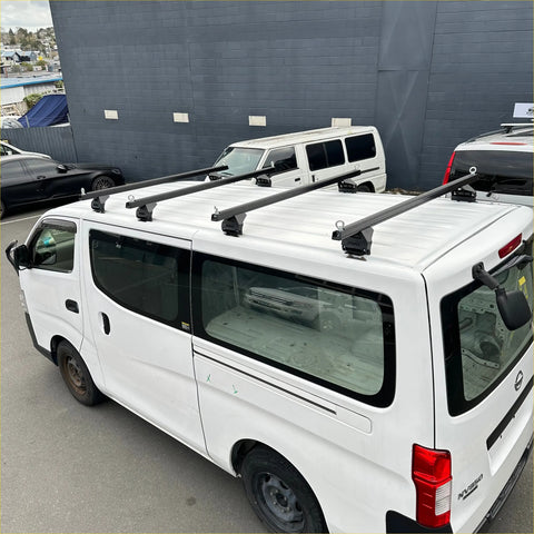 Black heavy duty roof rack 4 piece set mounted on the back of white nissan nv350 caravan 2012-current