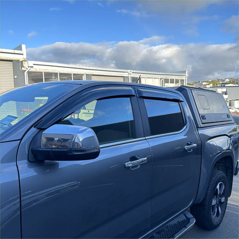 Dark gray metallic volkswagen amarok pickup with black hardtop canopy and chrome side mirrors featuring monsoons weather shields