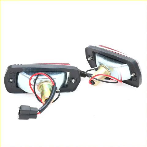 Backside of black plastic side marker lightset with red white reflectors and exposed wiring for nissan datsun 240z 260z 280z