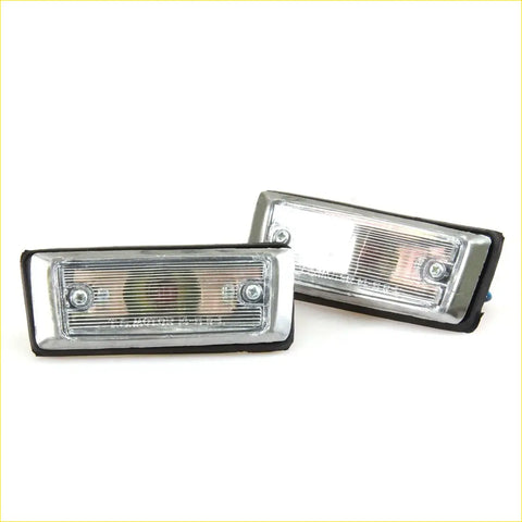 Pair of chrome rectangular side marker turn signal lights with clear lenses and black rubber trim for toyota hilux