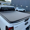 Gray fabric soft tonneau cover on the back of a white ford ranger 2022 double cab utility vehicle