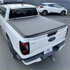 Gray fabric soft tonneau cover on the back of white ford ranger 2022 double cab pickup truck