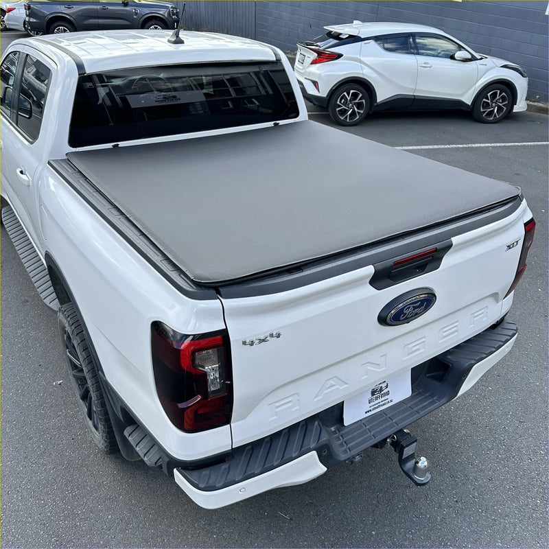 Gray fabric soft tonneau cover on the back of white ford ranger 2022 double cab pickup truck