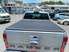 Silver ford ranger xlt double cab with black soft tonneau cover for px1 px2 px3 models 2012-2021 shown from back