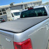 Gray textured soft tonneau cover fitted over the bed back side of a silver ford ranger px1 px2 px3 double cab pickup truck